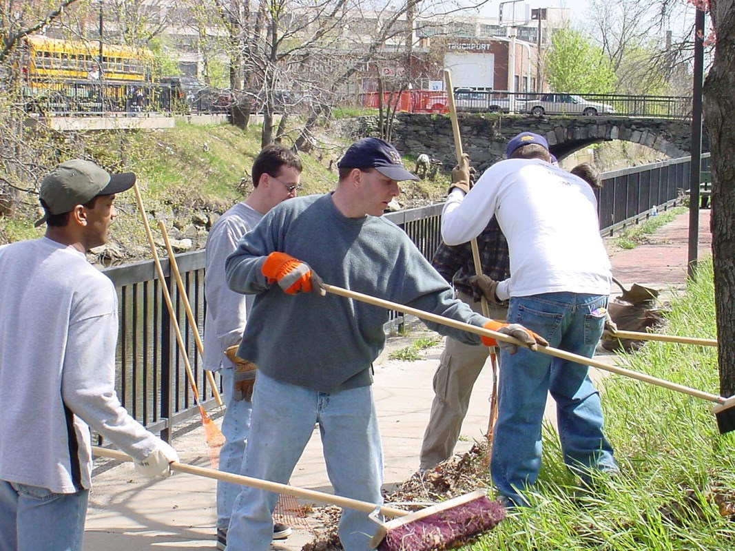 A group of volunteers clean a walkway