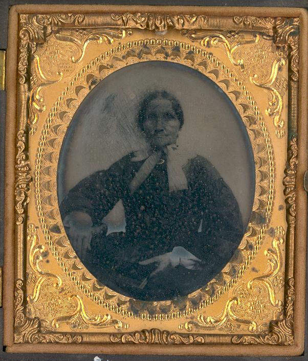 A black and white image of a woman in a gold frame.