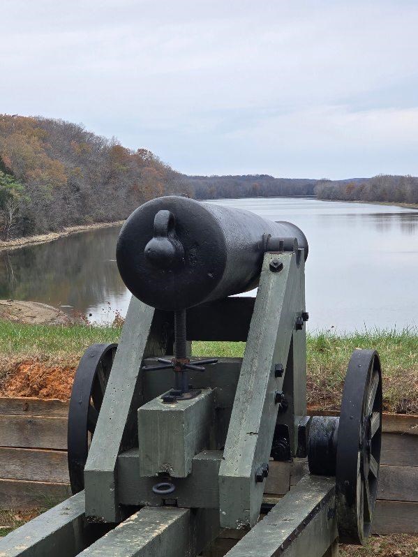 A 32lb. cannon on a seacoast artillery carriage looks downstream on Lake Barkley (Cumberland River).