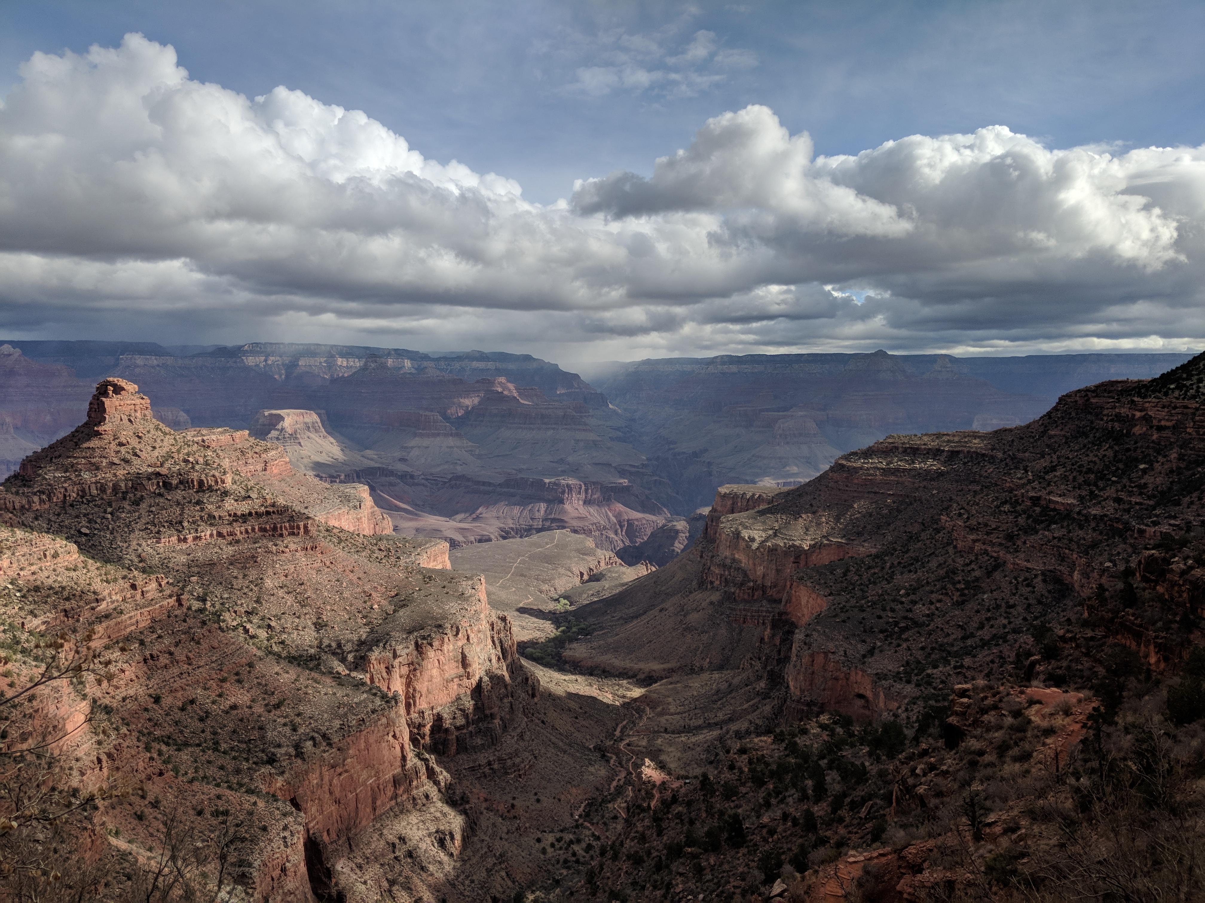 Landscape photo of the canyon with clouds and sun rays.