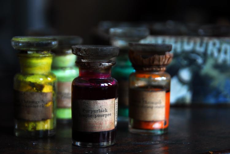 Paint bottles on a table.