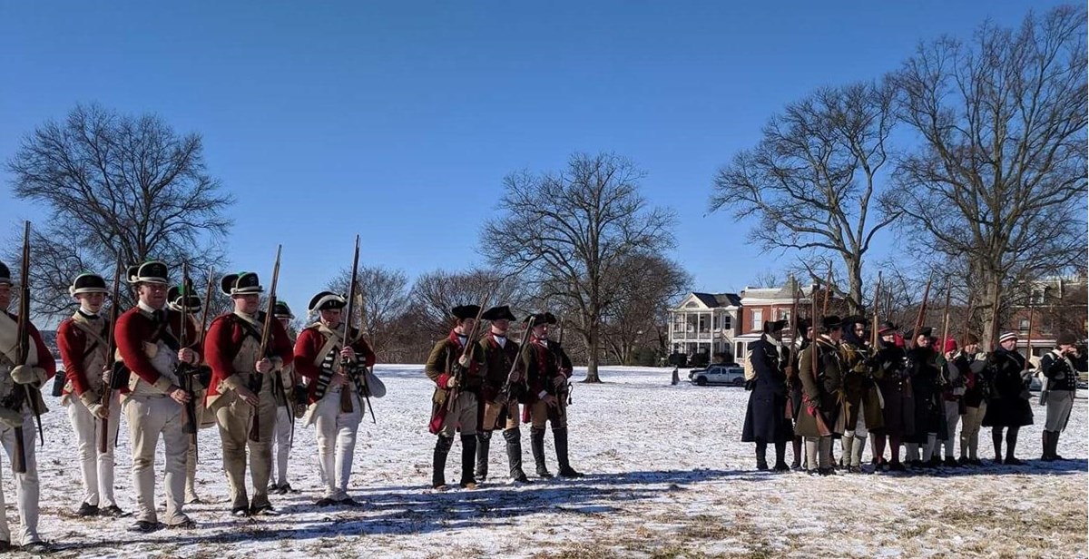 A line of soldiers in Revolutionary War era military attire.