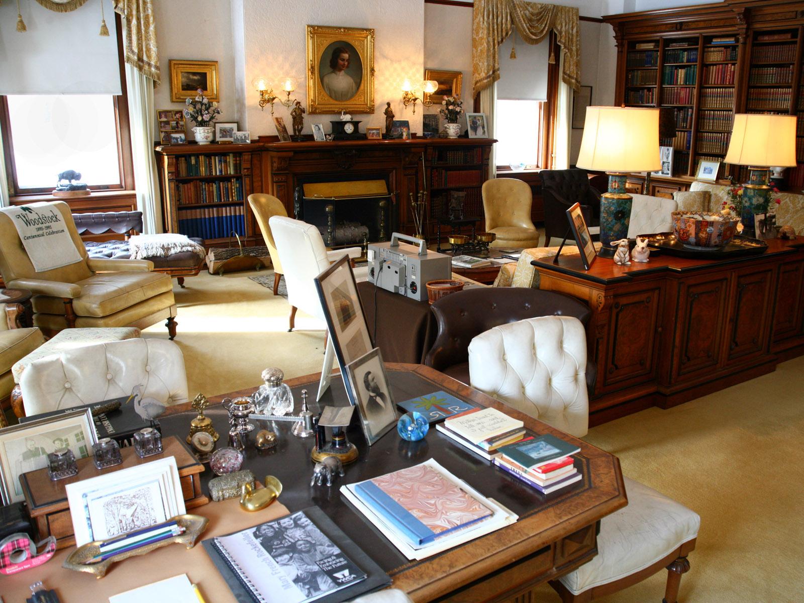 Mansion Library with view of desk, books, artwork