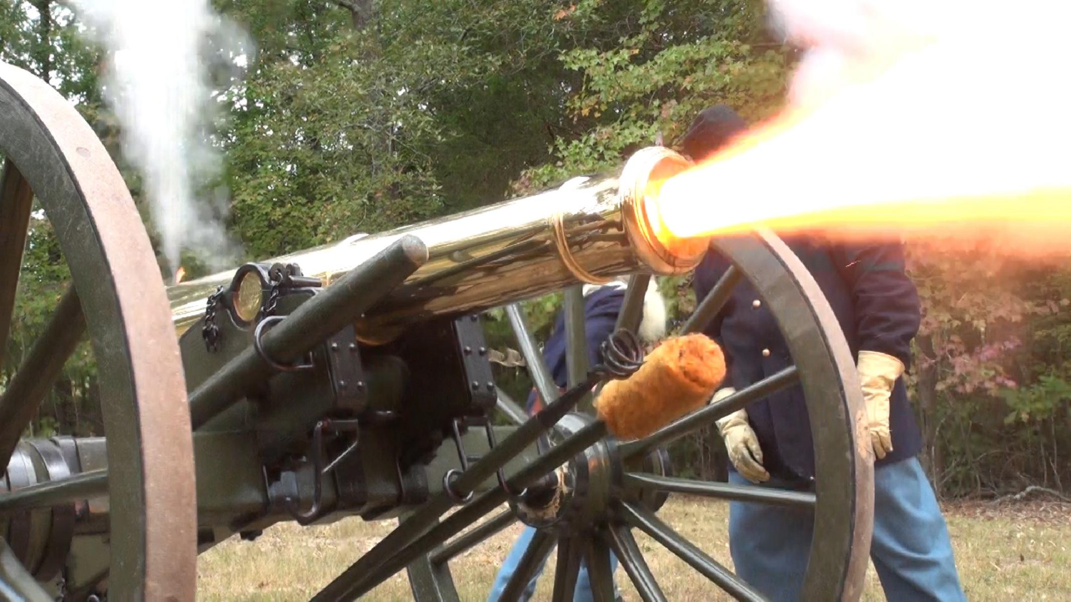 A bronze cannon belching fire and smoke.