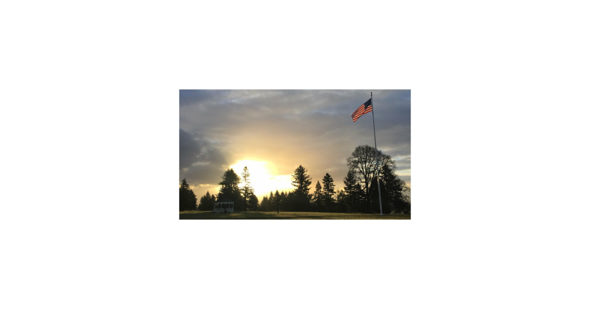 Sunrising over the Vancouver Barracks silhouetting the flagpole proudly flying the garrison flag