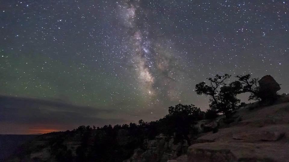 A night sky on the rim of the canyon with stars and constellations