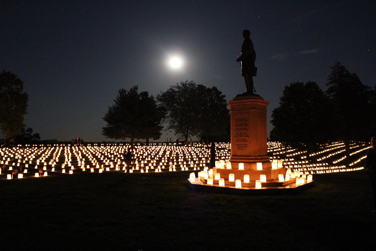 The Humphries Monument sits in the center of the cemetery, surrounded by luminarias.