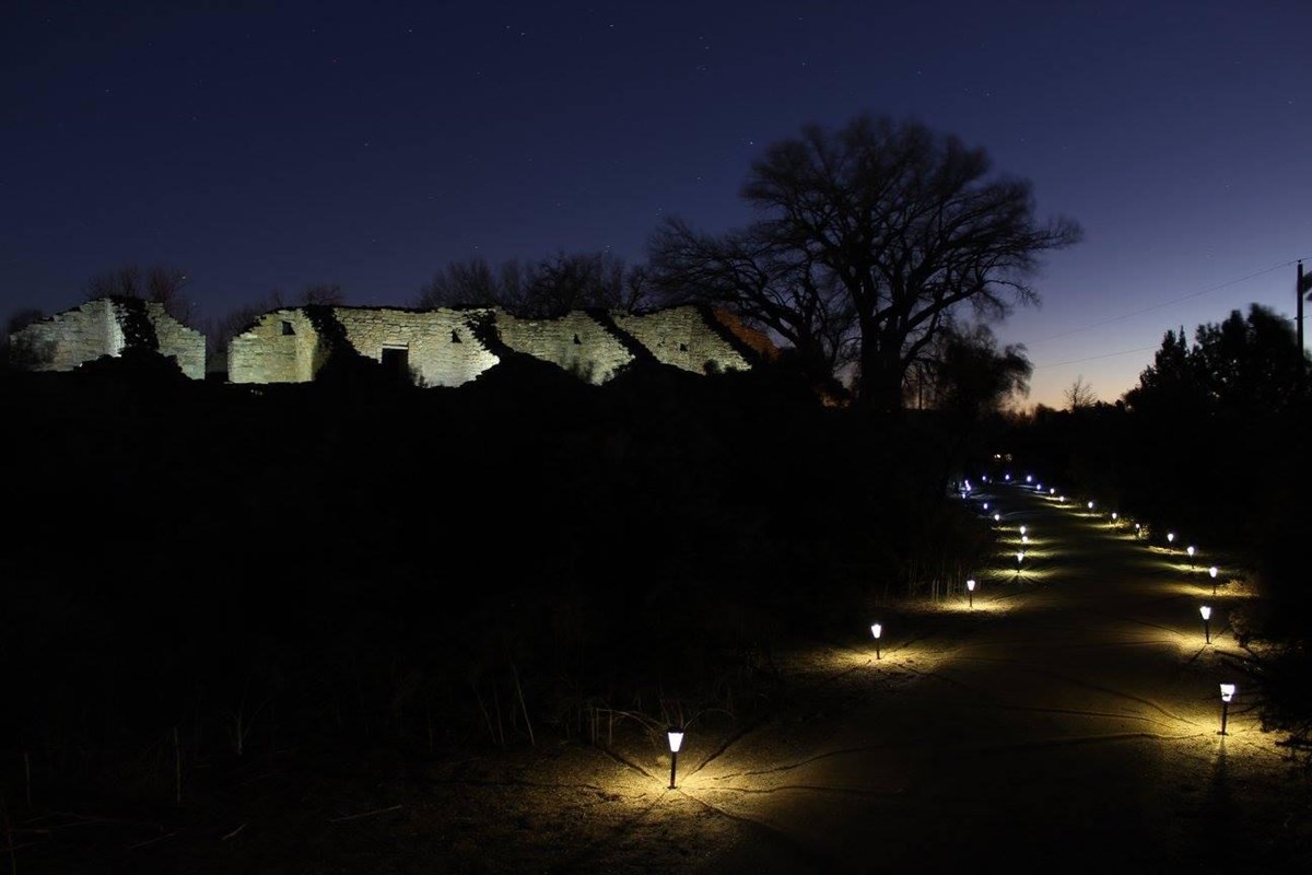 The walkway to the great house with lanterns shining bright on either side.
