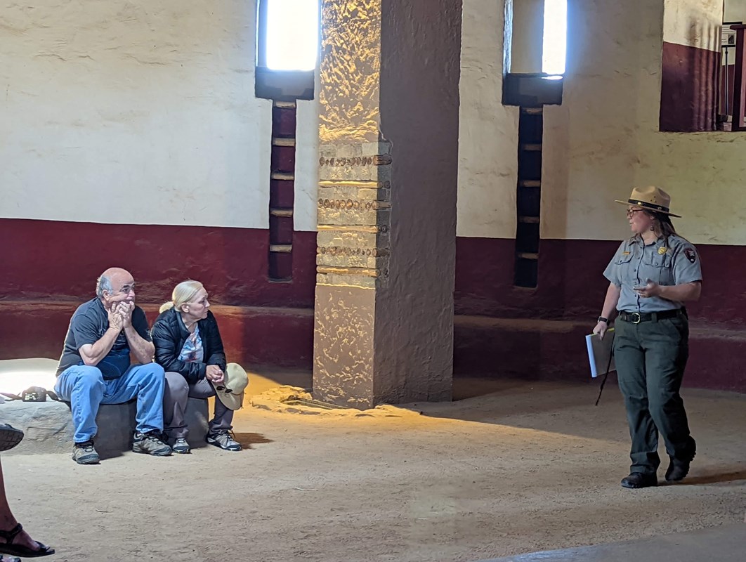 A ranger giving a talk to visitors inside the Great Kiva.