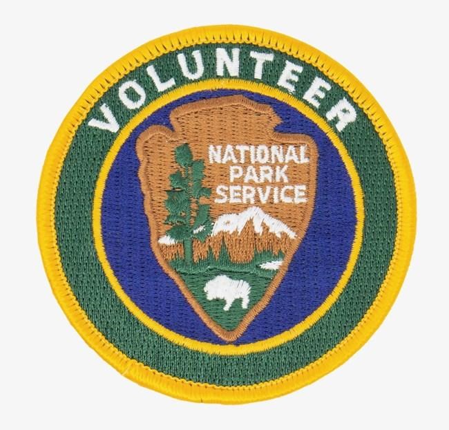 An embroidered patch showing the NPS Volunteer logo