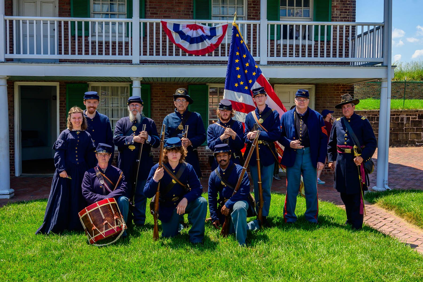 Living history volunteers in Civil War uniform in front of Fort McHenry barracks