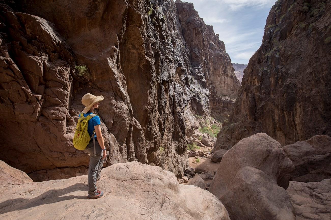 Hiker stands in a narrow canyon