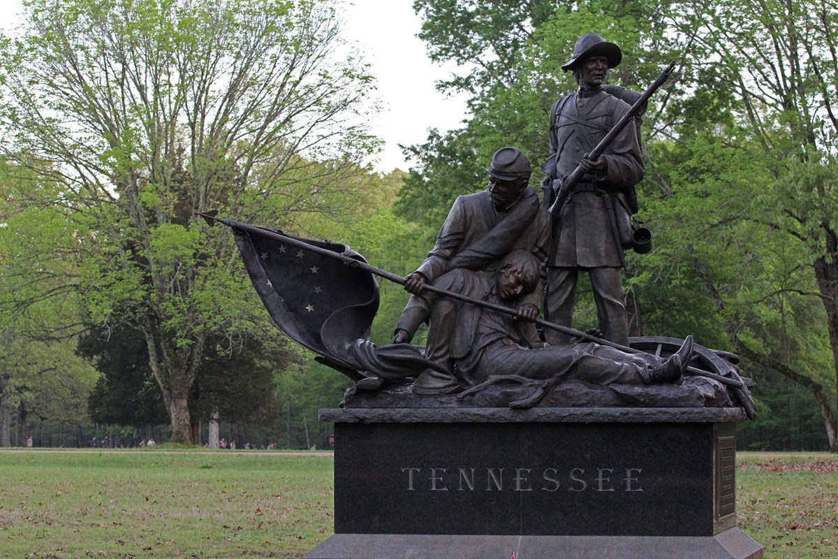 Monument with three bronze soldiers on top.
