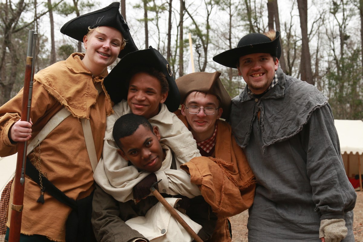 Young volunteers in colonial clothing
