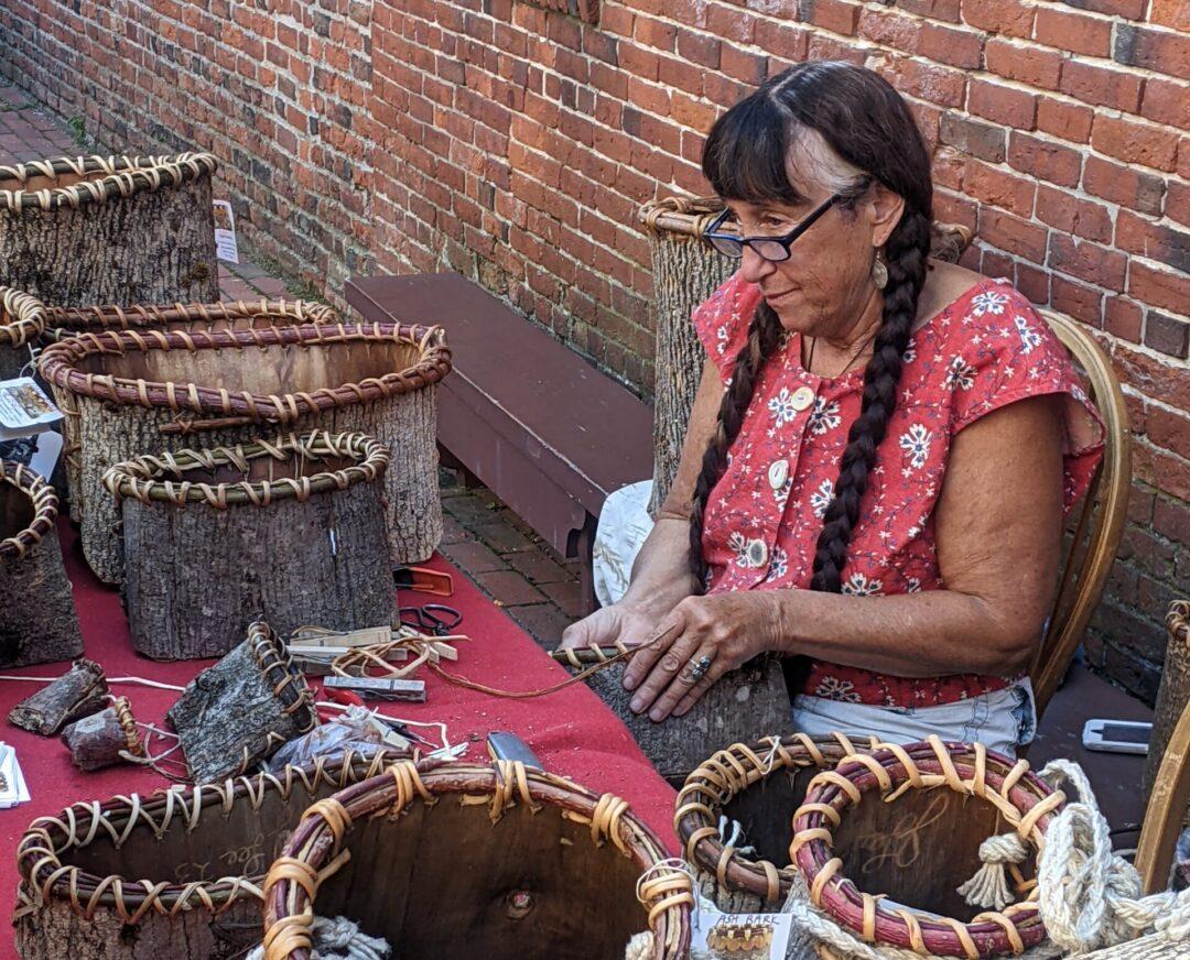 Jennifer Lee demonstrates bark basket weaving in the Revere House courtyard