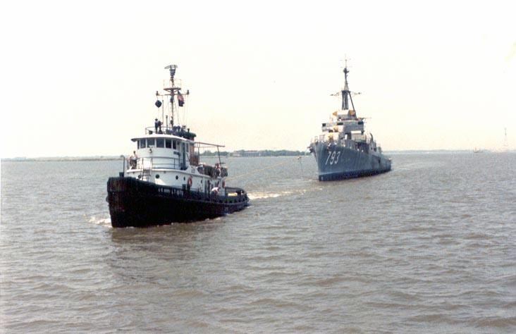 USS CASSIN YOUNG being pulled by a tug boat.