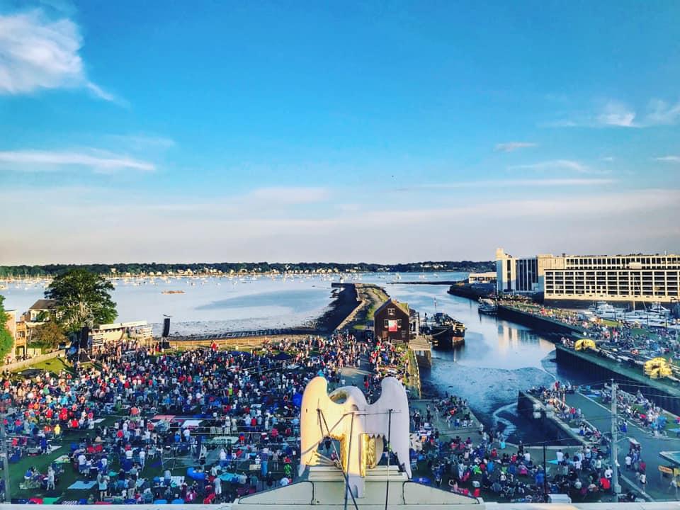 A crowd gathers along the coast for a festival