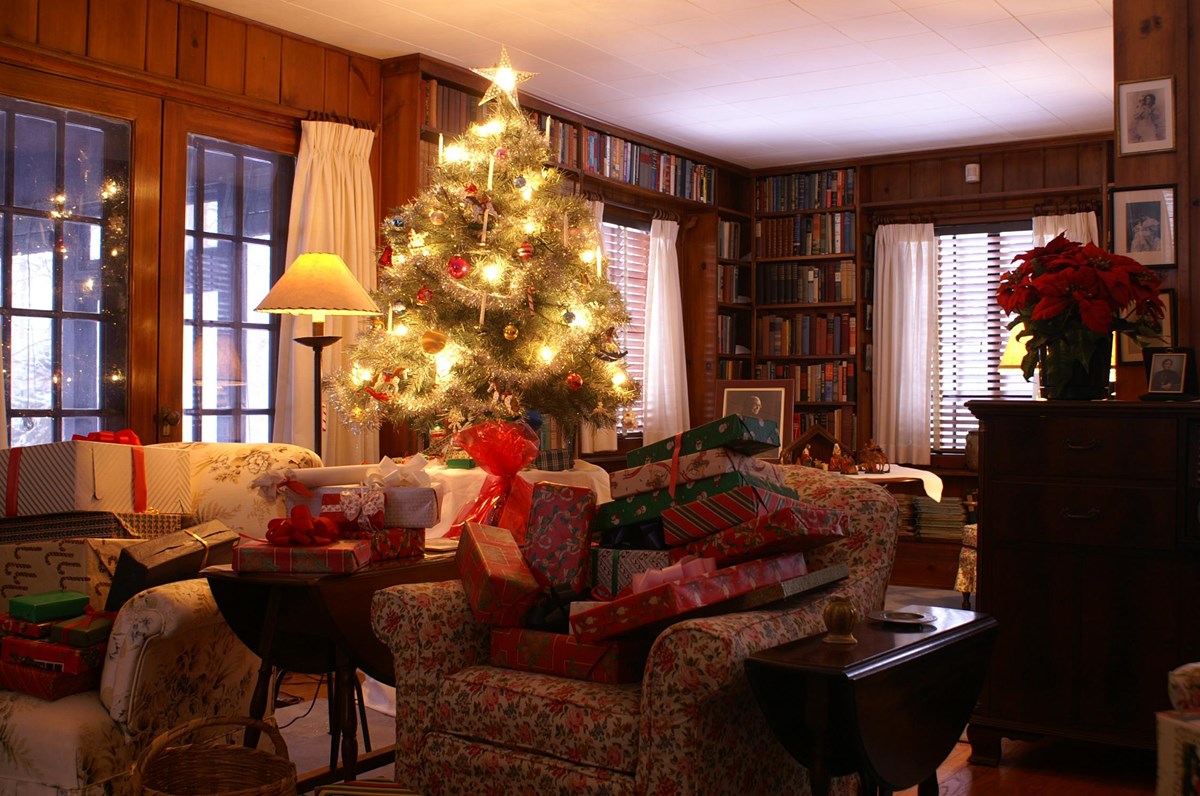 A paneled room with small table top tree decorated for Christmas.