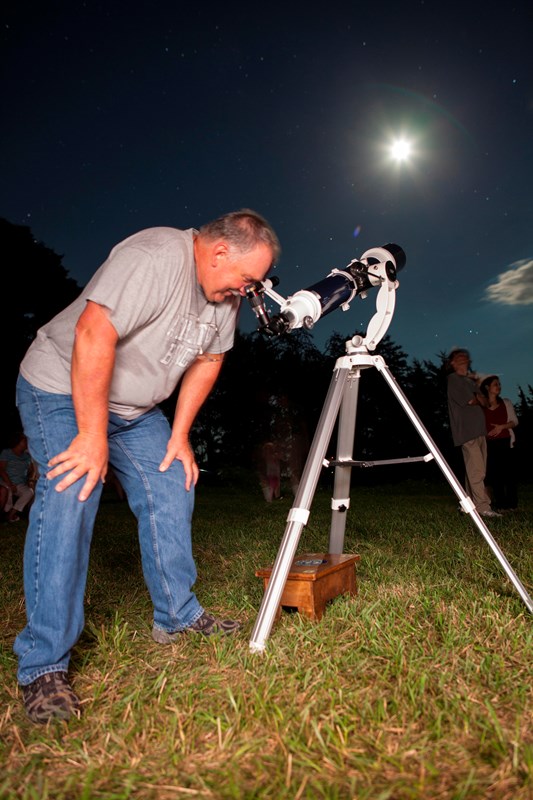 Astronomer looking through his telescope.