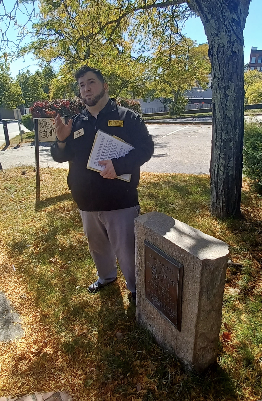Man standing next to monument