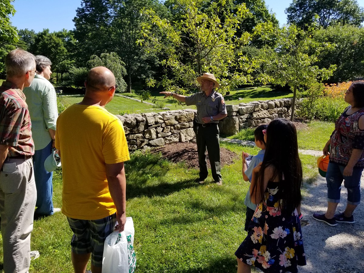 A park ranger leads a group of people on a tour.