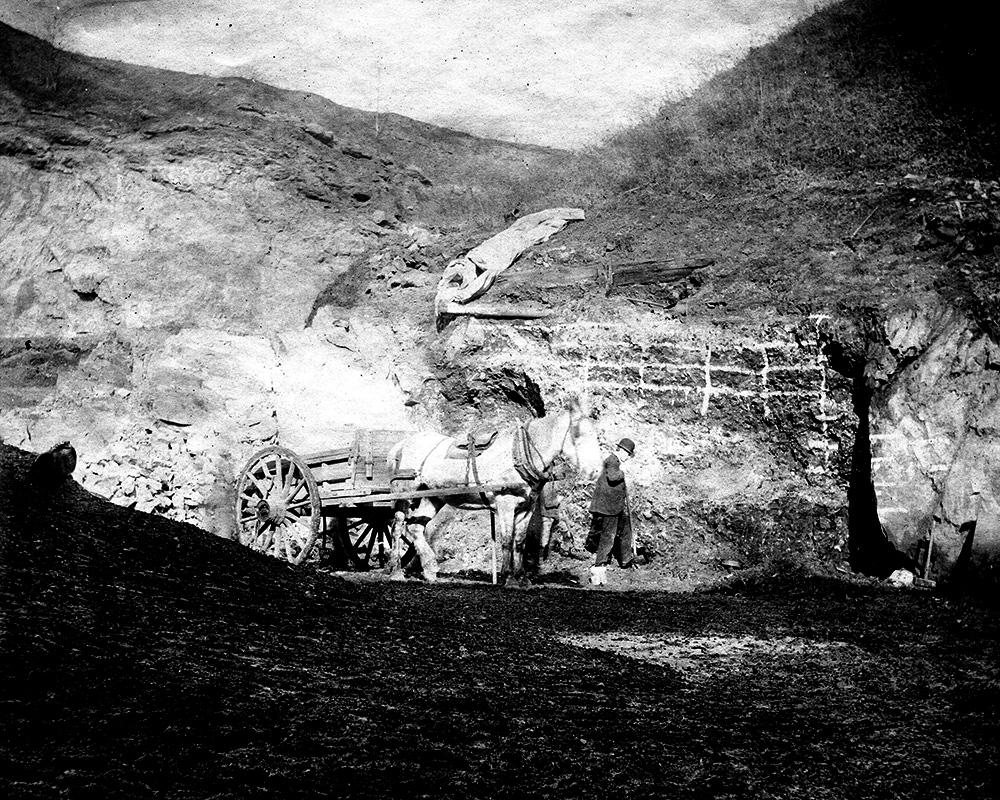 black and white photograph of an exposed rock wall with a grid layout