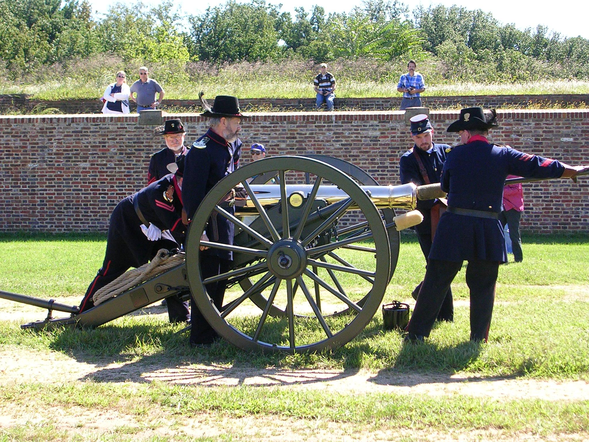 Visitors look as five volunteers dressed in Civil War Clothing load the cannon