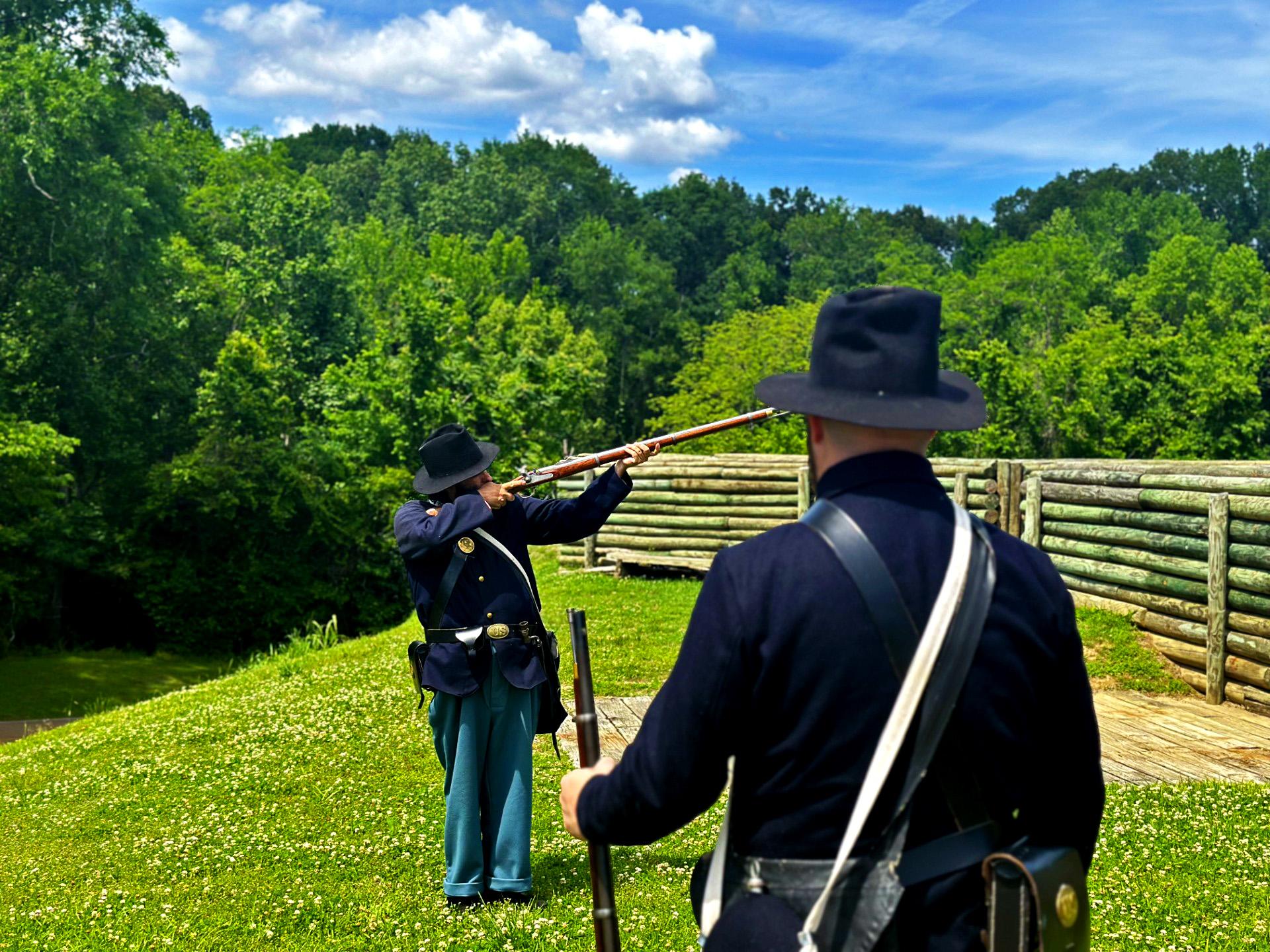 Living Historians in Civil War uniform demonstrating the rifled musket firing drill