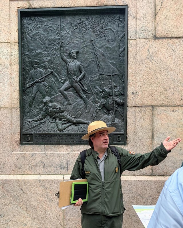 Ranger standing in front of plaque commemorating the Battle of Harlem Heights