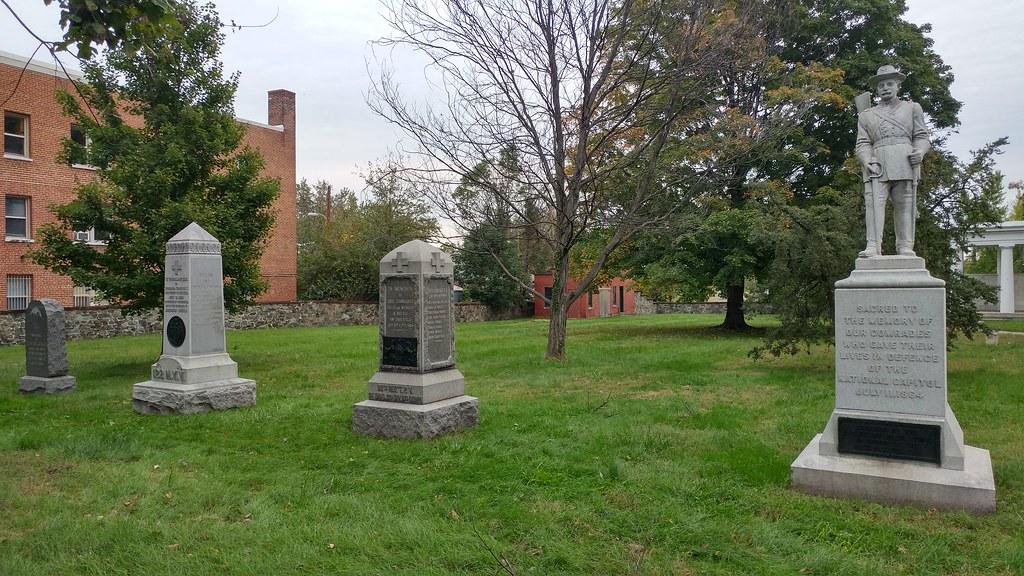 Several monuments arranged in a grassy area, creating a peaceful and reflective atmosphere.