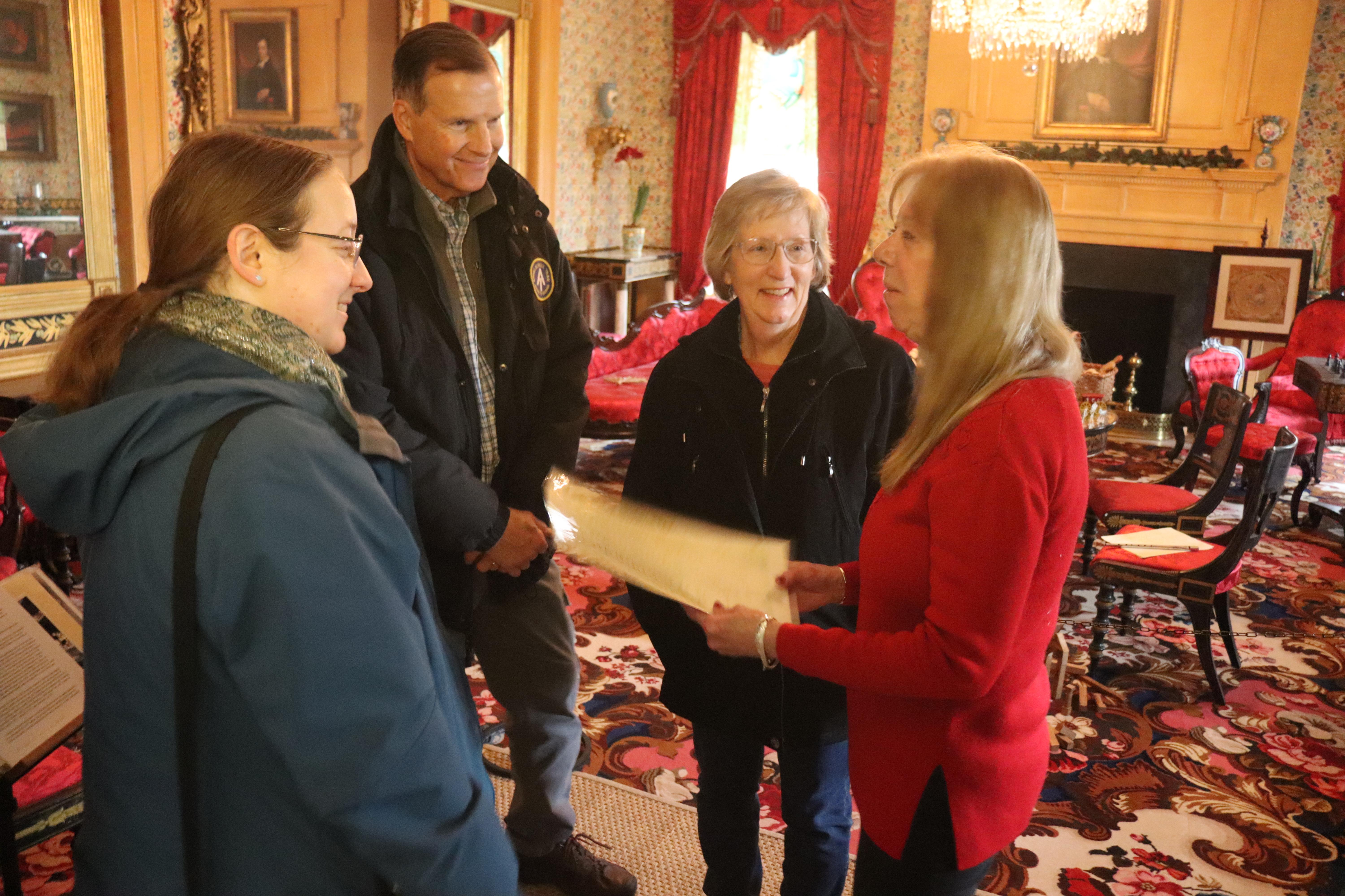 Visitor talking to one of our volunteers on a tour of the mansion