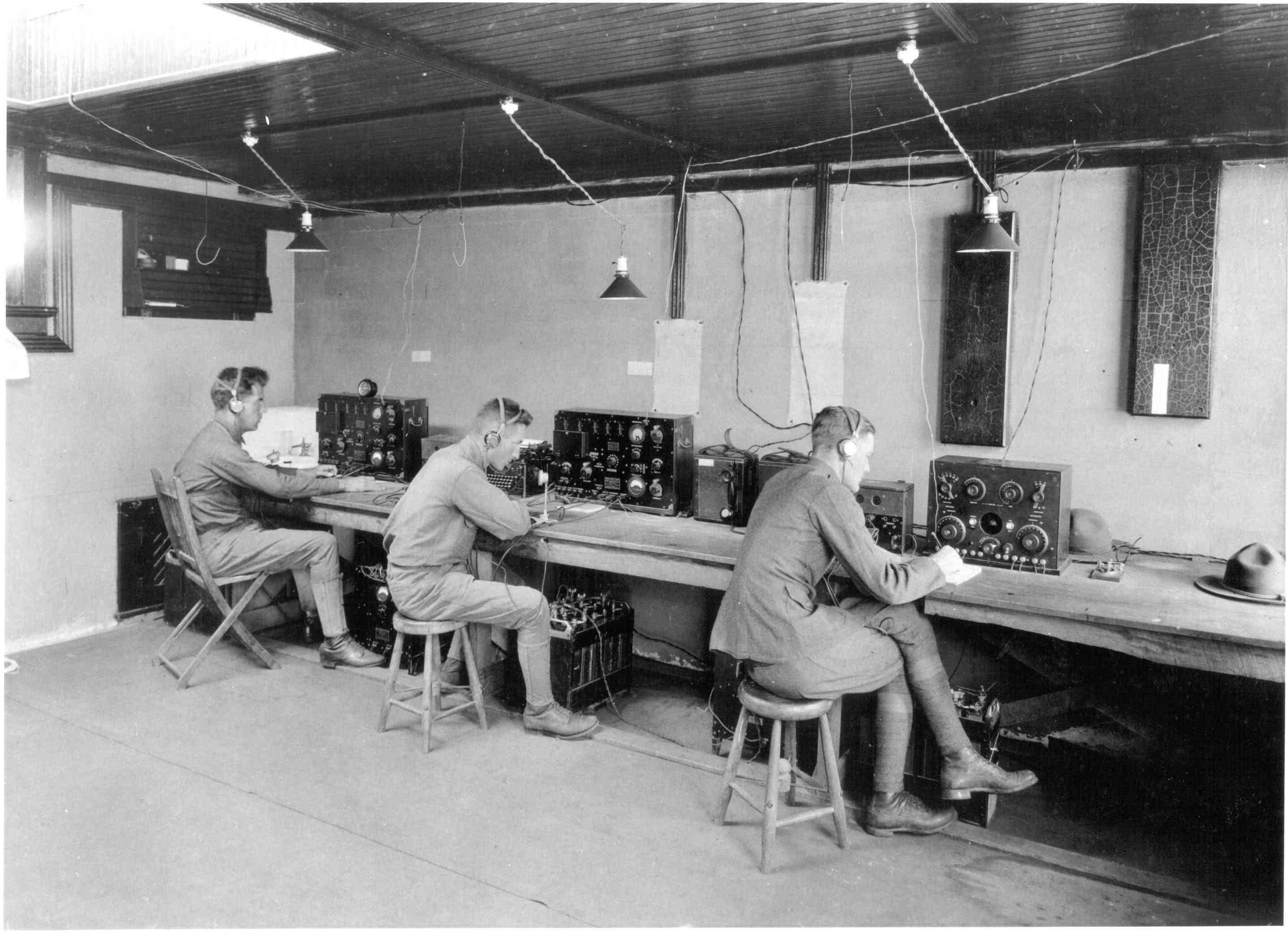 Three soldiers operating radio system