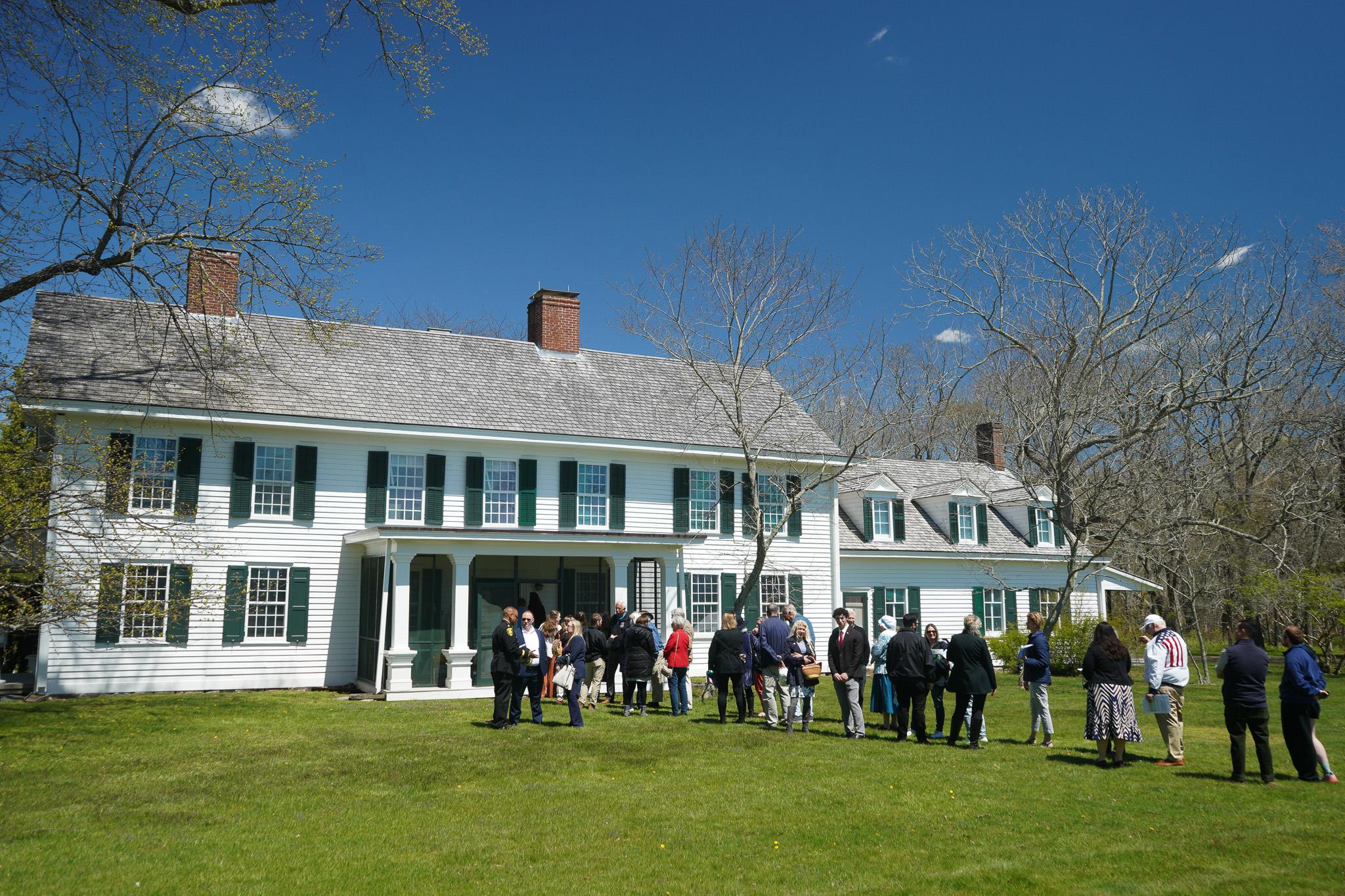 A group lines up in from the Old Mastic House.