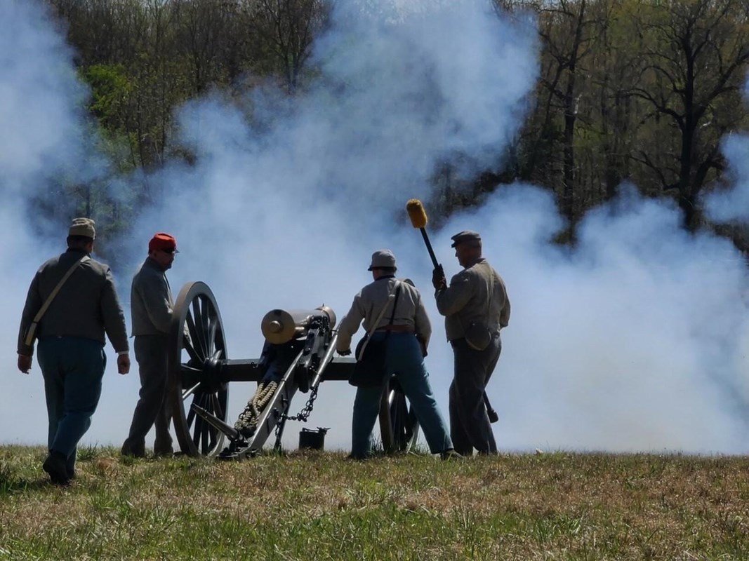 Smoke belches from a cannon just fired by living historians.