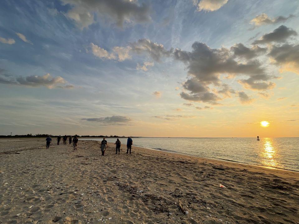 Group of people hiking on sand