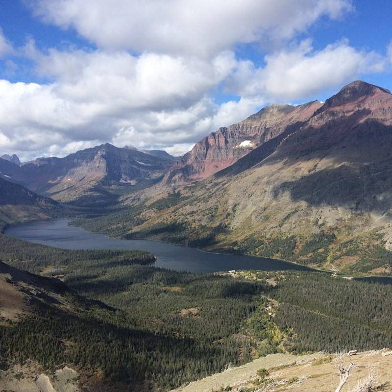 Looking down at a lake surrounded by forests and mountains