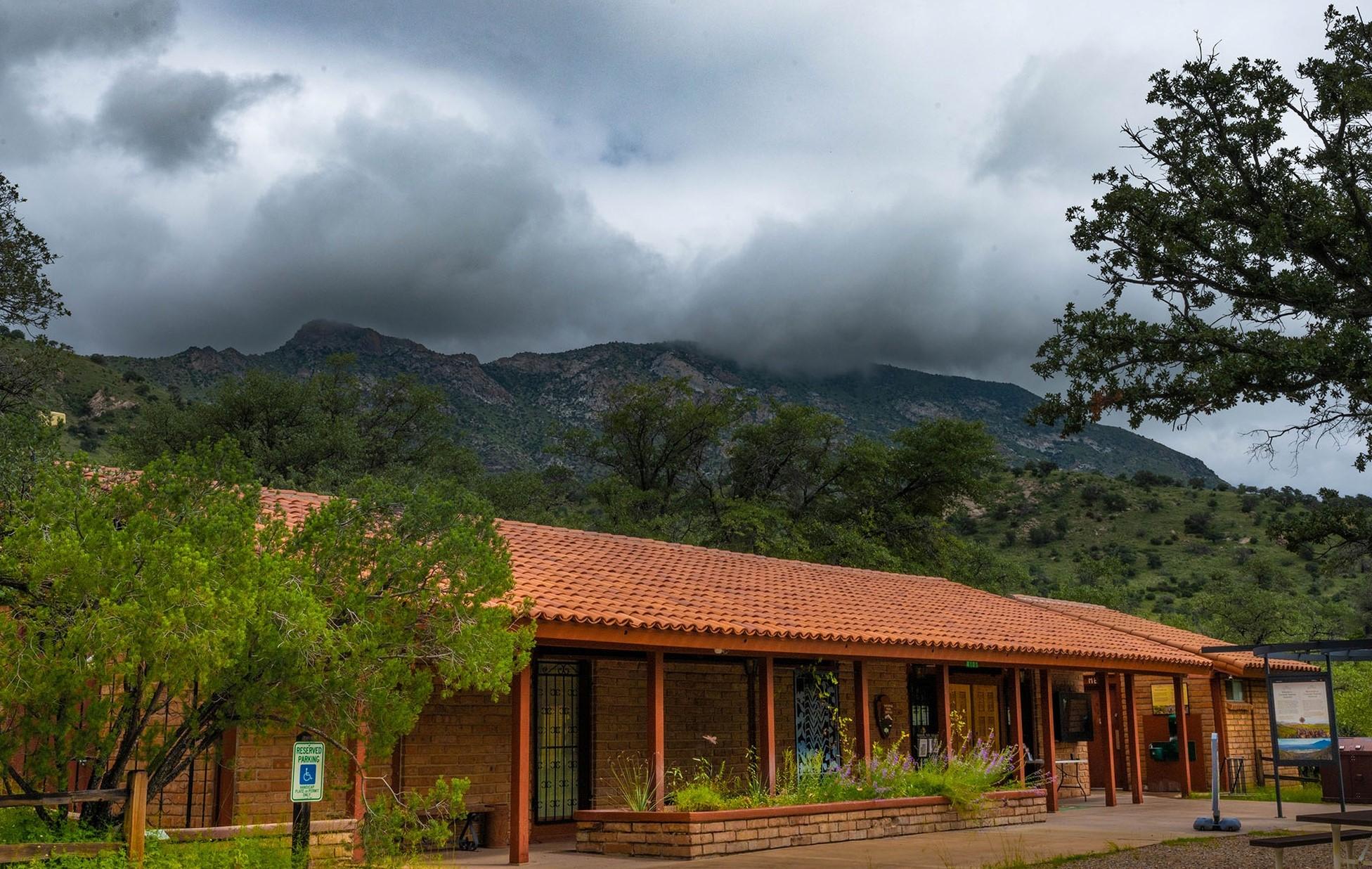 building with mountain and clouds in the background