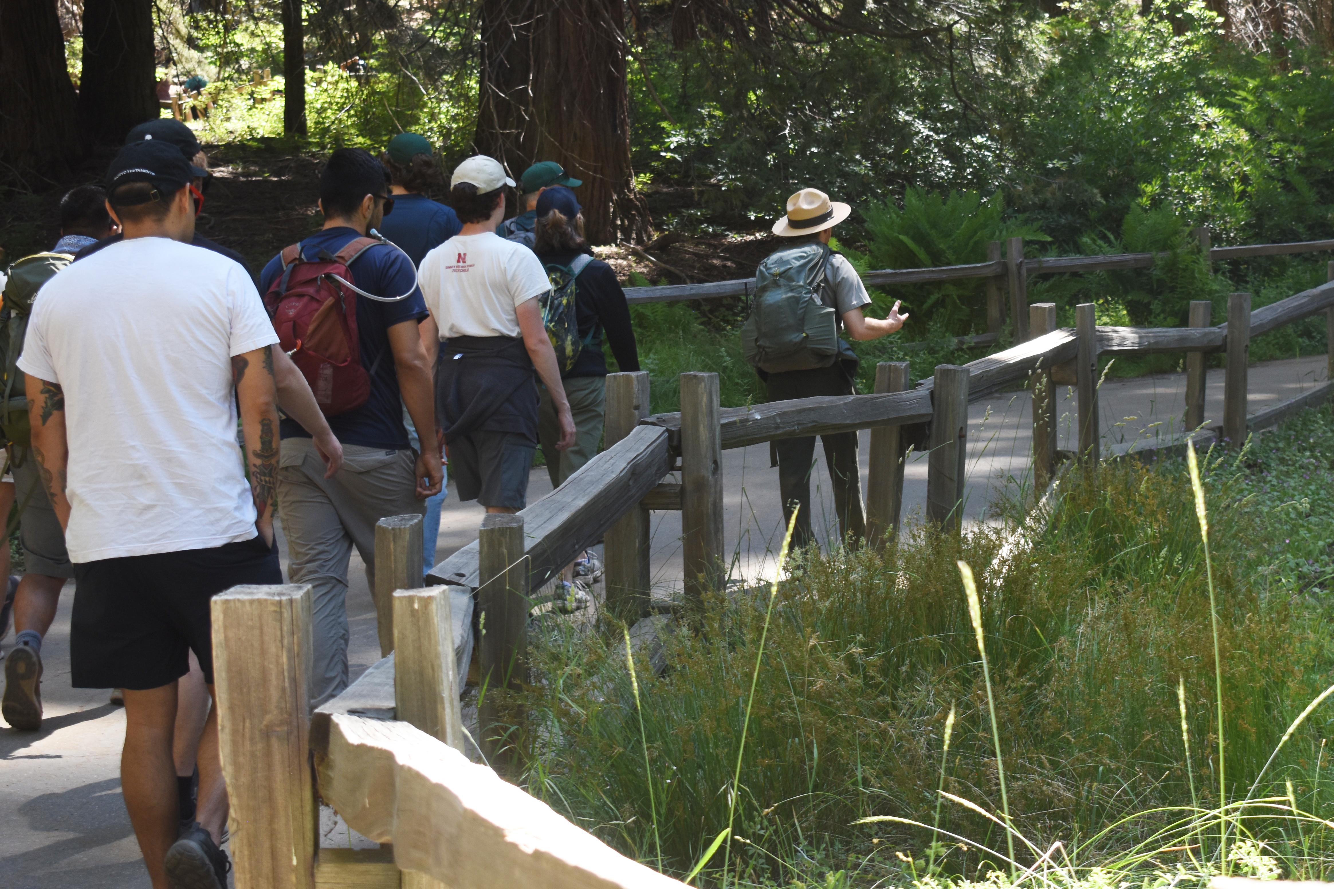 A park ranger leads a group hike.