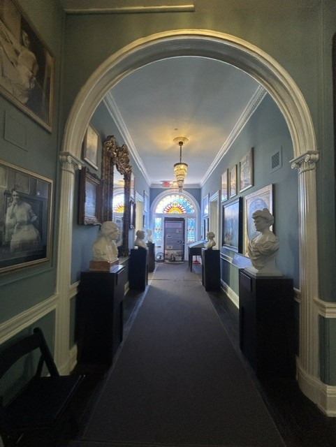 Hall of Honor in Belmont-Paul museum with portraits on the walls and busts on pedestals
