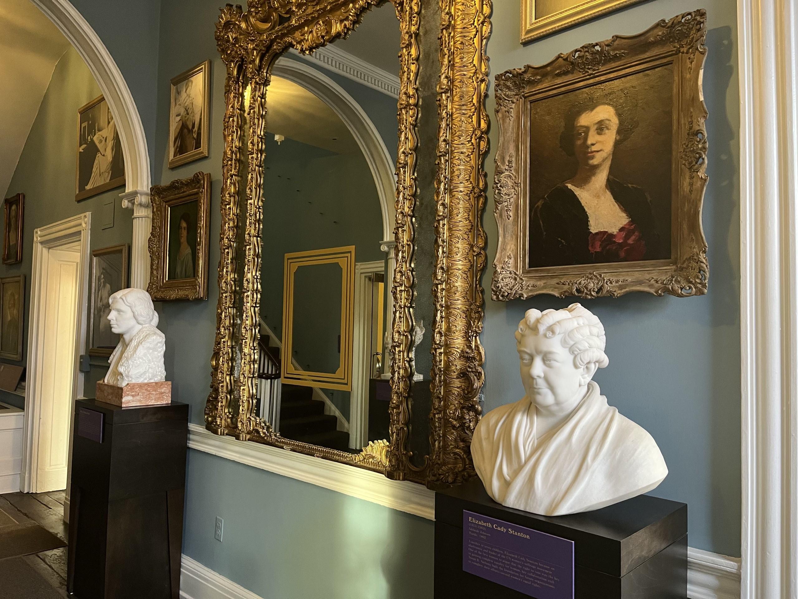 View of Belmont-Paul Hall of Honor with busts on either side of a gilded mirror