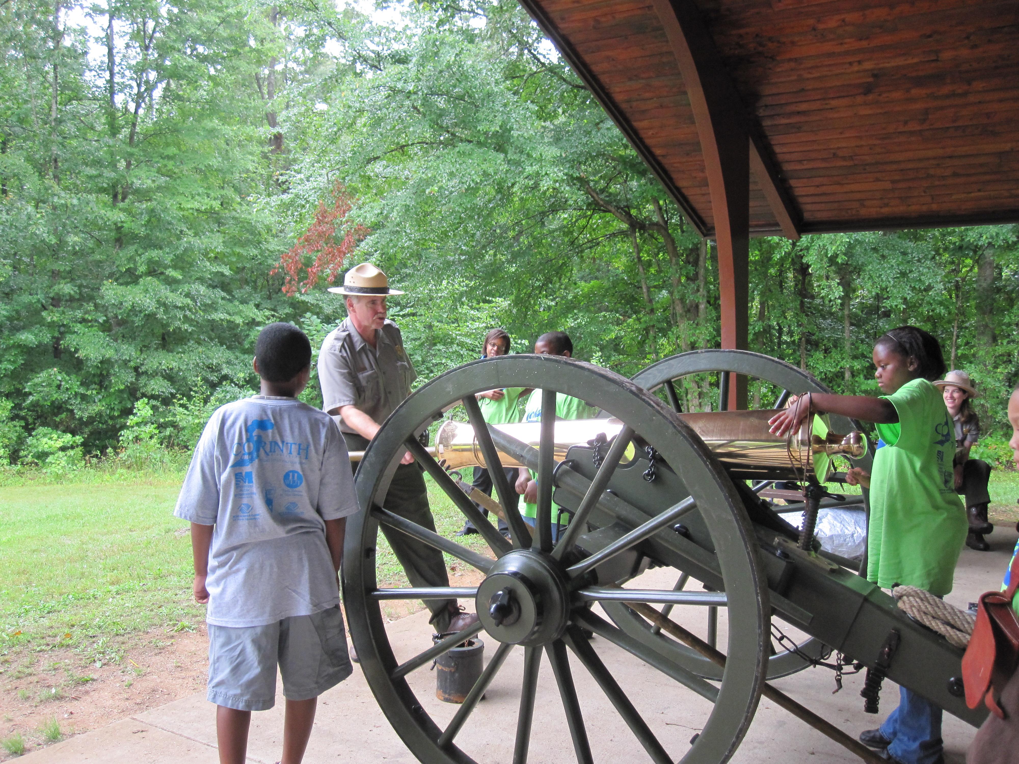 A park ranger teaches kids about the cannon