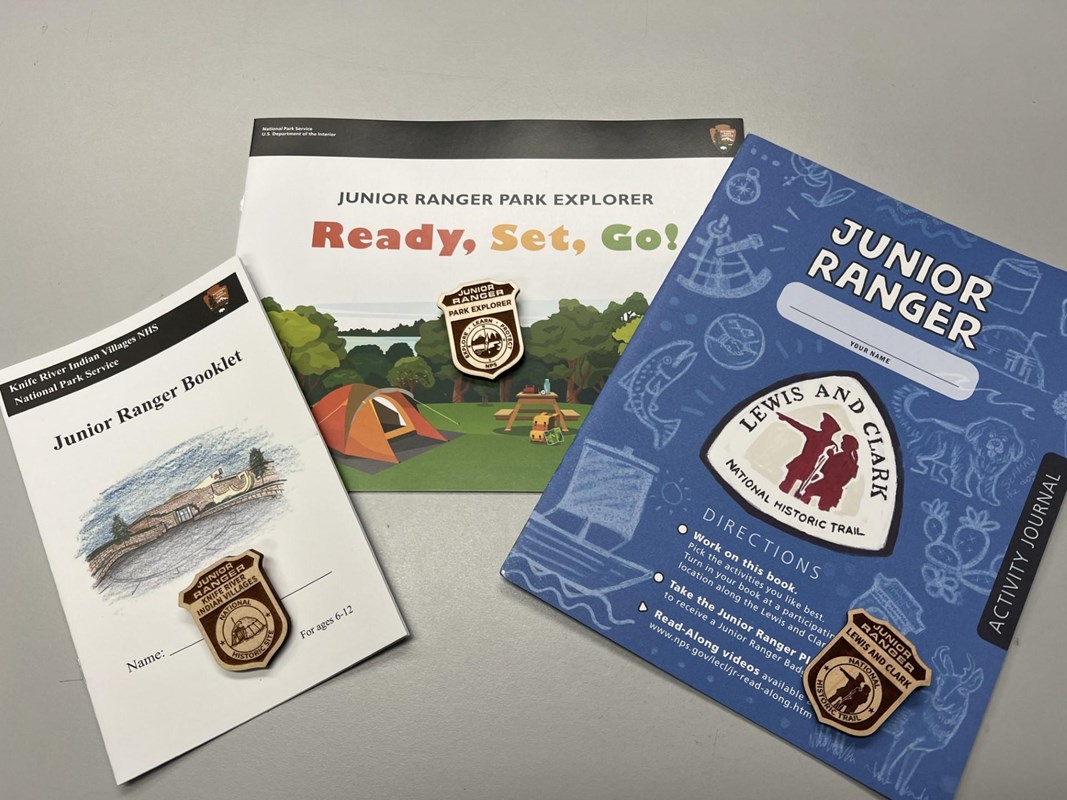 Three Junior Ranger Booklets and badges