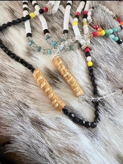Colorful beads on a strand resting a grey and brown fur.