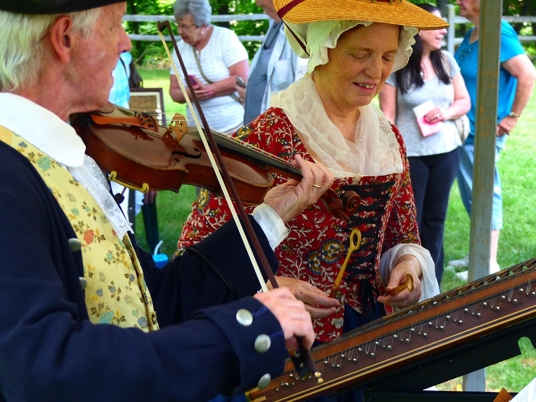 two musicians in historical clothing playing instruments