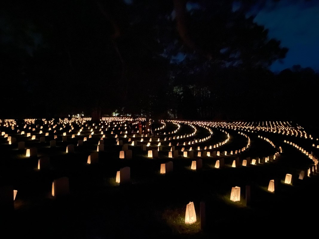 Luminaries in a circular pattern light up a dark night.