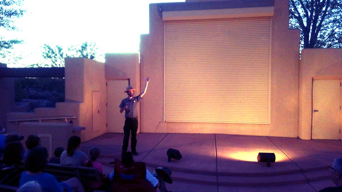 Park Ranger speaking in front of dusky backdrop