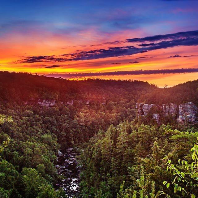 The sun setting over a rugged landscape