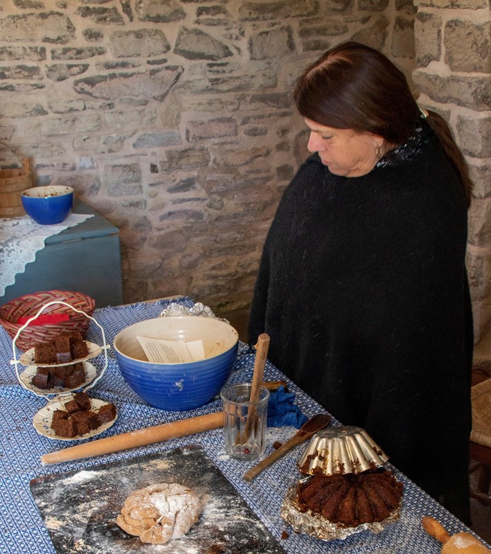 Woman making gingerbread in the summer kitchen
