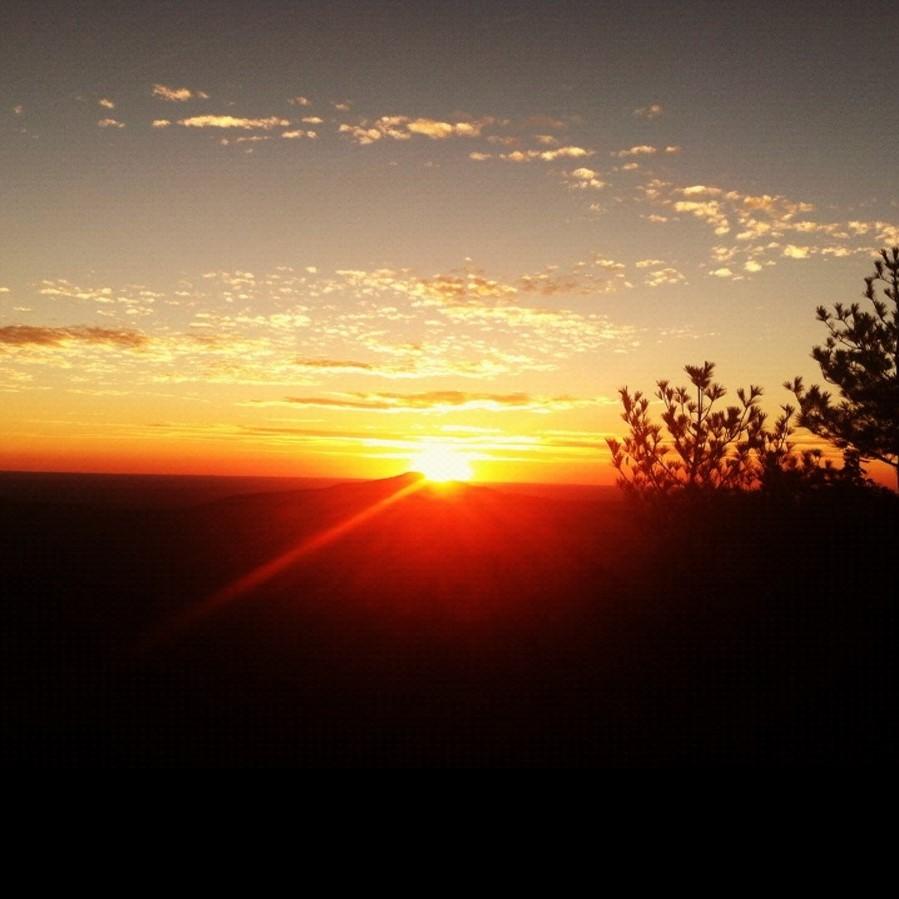 The sun setting over a rugged landscape