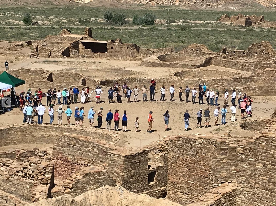 Visitors and dancers gathering at Pueblo Bonito.